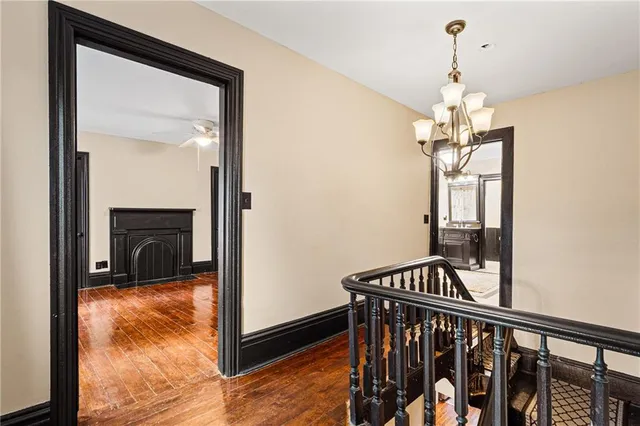 a view of a hallway with furniture and chandelier