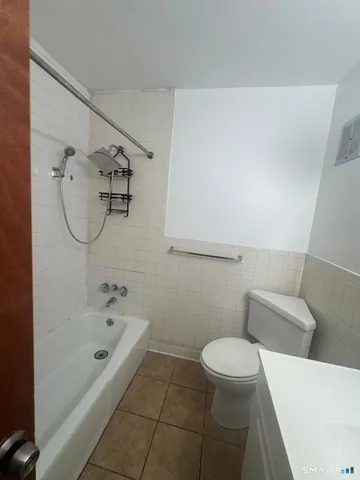 a bathroom with a bathtub and toilet