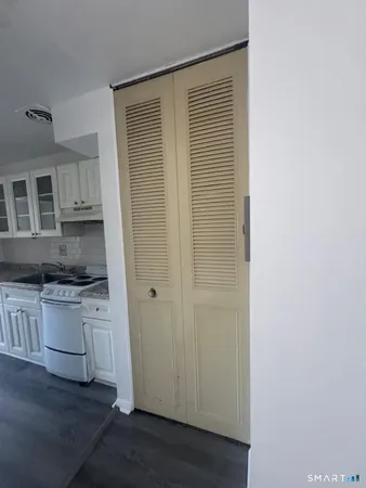 a kitchen with a refrigerator and white cabinets
