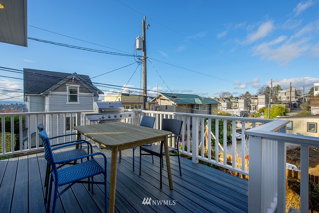 710 West Howe Street Seattle, WA 98119 - Photo 36 of 40 a view of a roof deck with table and chairs