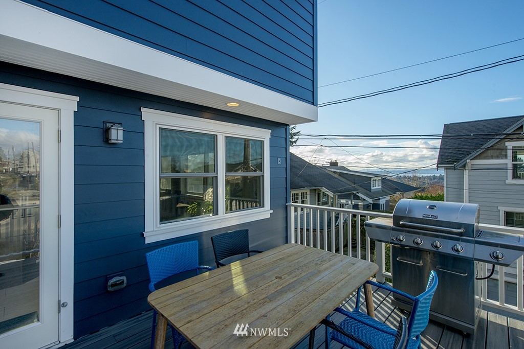 710 West Howe Street Seattle, WA 98119 - Photo 37 of 40 a view of a deck with table and chairs with wooden floor and wall