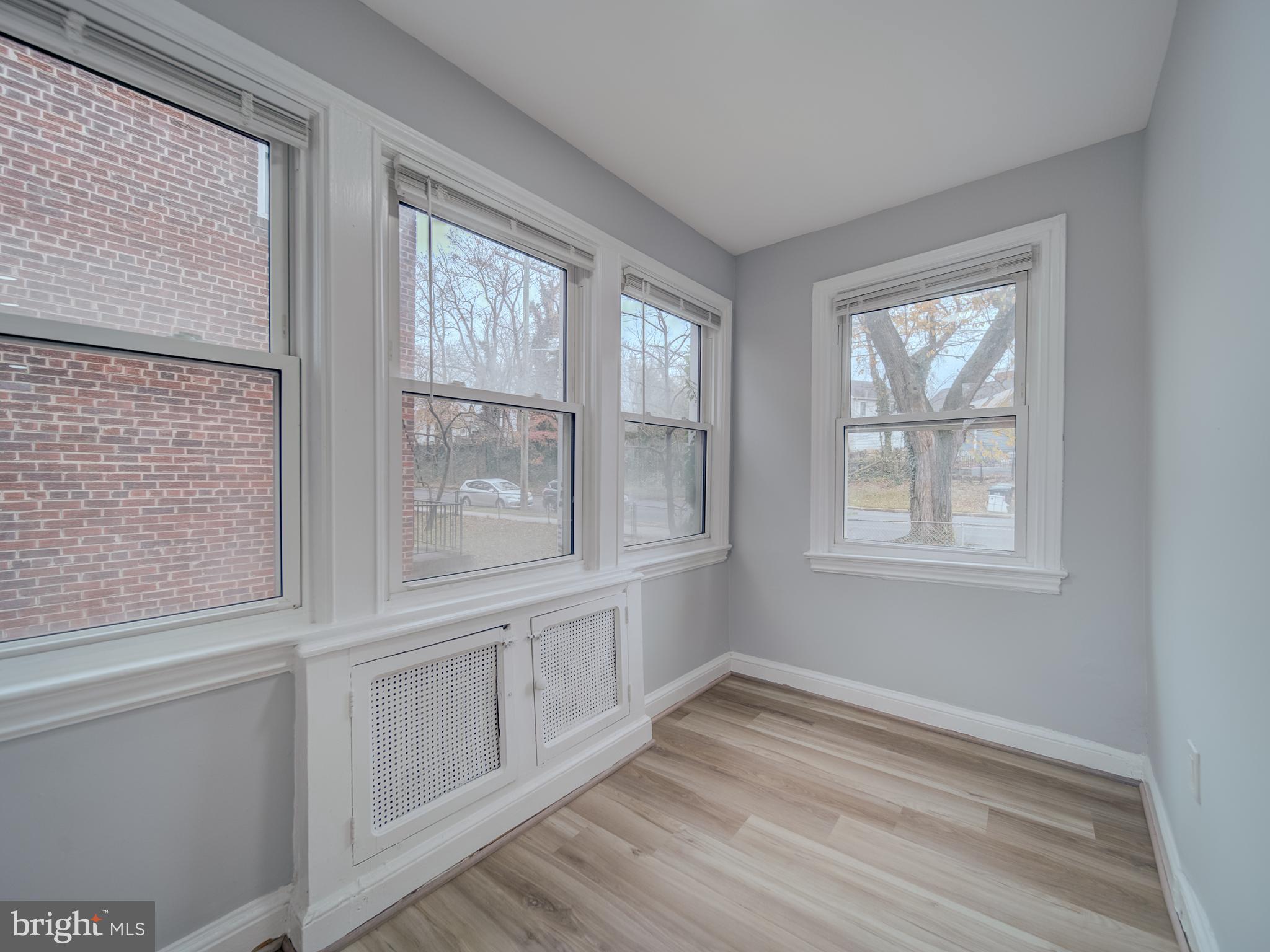 4308 Alabama Avenue Southeast Washington, DC 20019 - Photo 16 of 47 a view of an empty room with wooden floor and a window