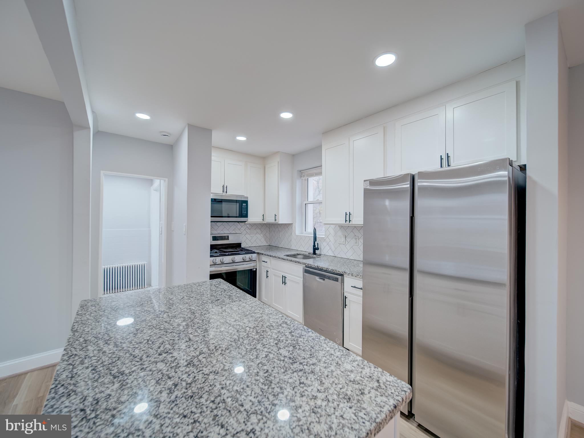 4308 Alabama Avenue Southeast Washington, DC 20019 - Photo 18 of 47 a kitchen with stainless steel appliances granite countertop a refrigerator and a stove top oven