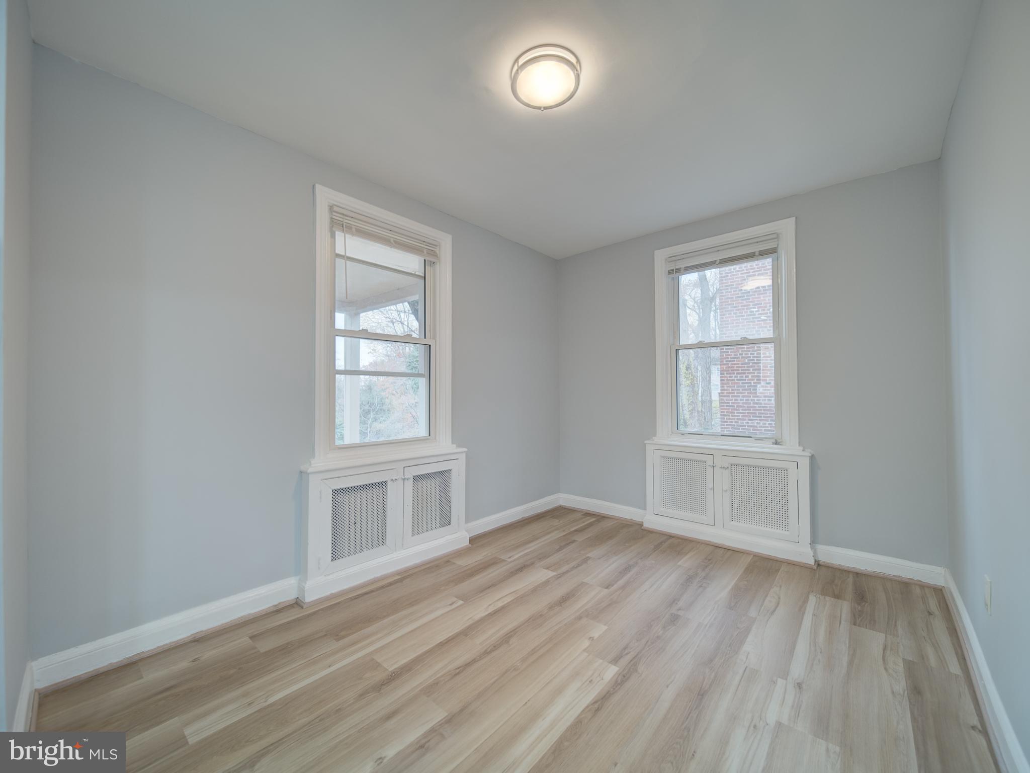 4308 Alabama Avenue Southeast Washington, DC 20019 - Photo 22 of 47 an empty room with wooden floor and windows
