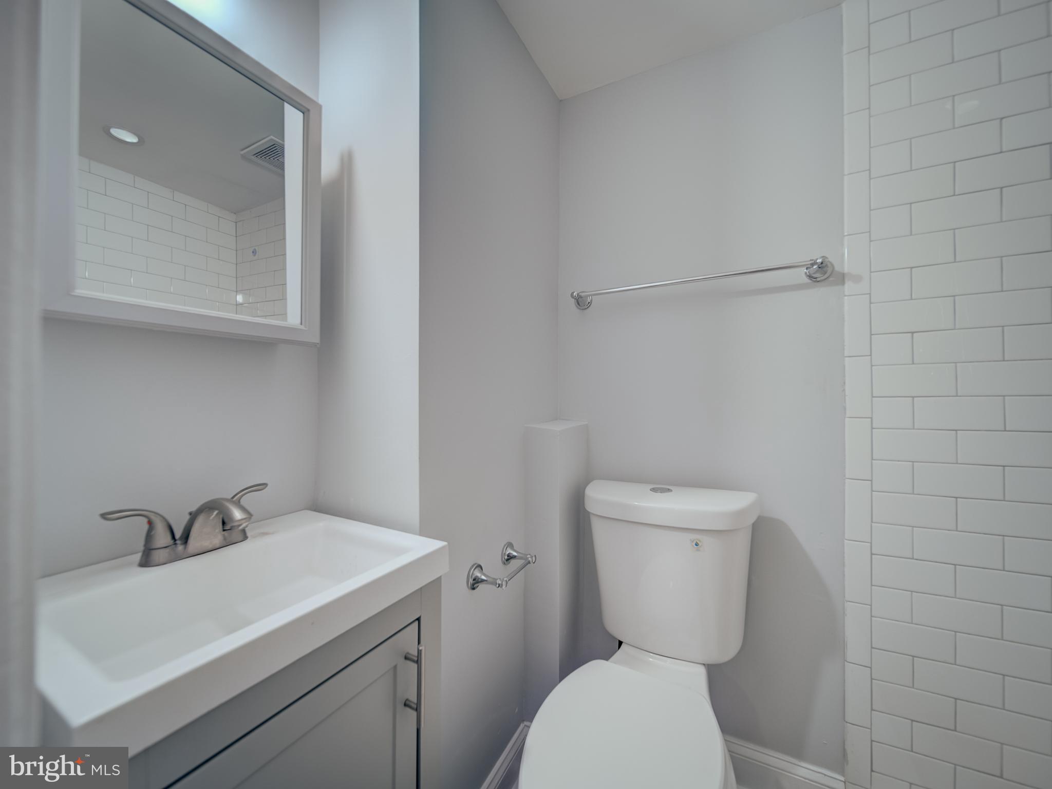 4308 Alabama Avenue Southeast Washington, DC 20019 - Photo 27 of 47 a bathroom with a sink toilet and a mirror