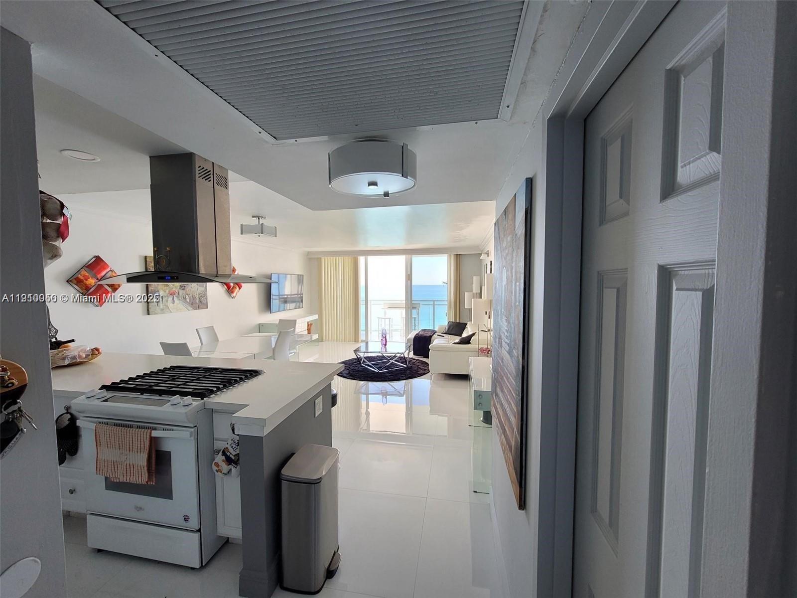 2030 South Ocean Drive, Unit 1815 Hallandale Beach, FL 33009 - Photo 11 of 20 a kitchen that has a lot of cabinets in it