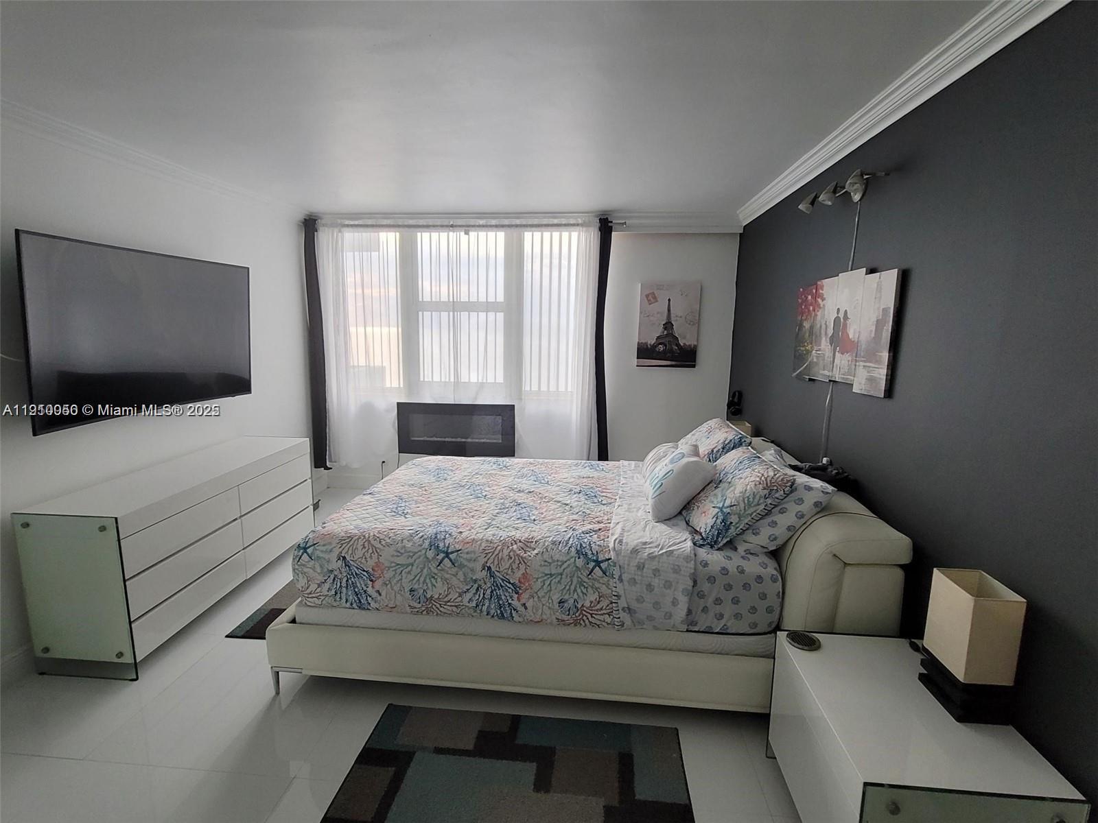 2030 South Ocean Drive, Unit 1815 Hallandale Beach, FL 33009 - Photo 12 of 20 a bedroom with a bed and a flat screen tv