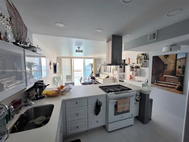 a kitchen that has a lot of cabinets in it