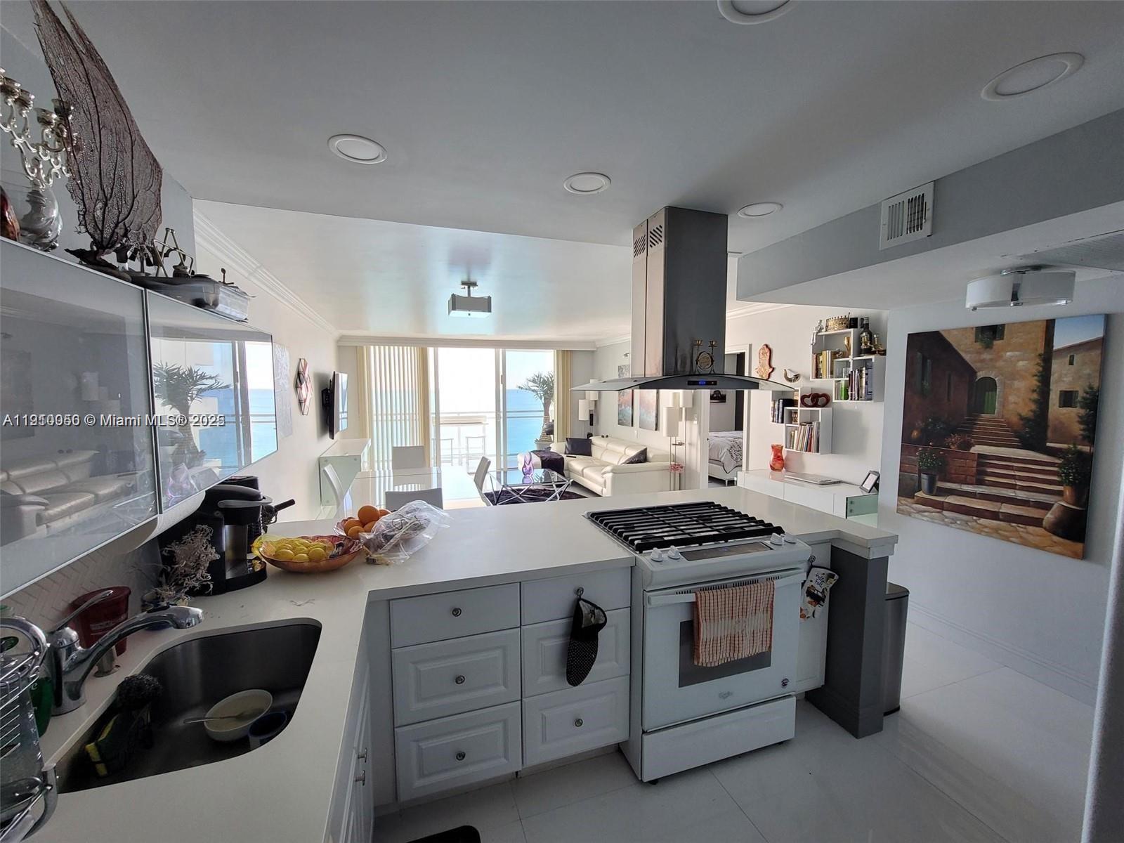 2030 South Ocean Drive, Unit 1815 Hallandale Beach, FL 33009 - Photo 10 of 20 a kitchen with stove a sink and cabinets