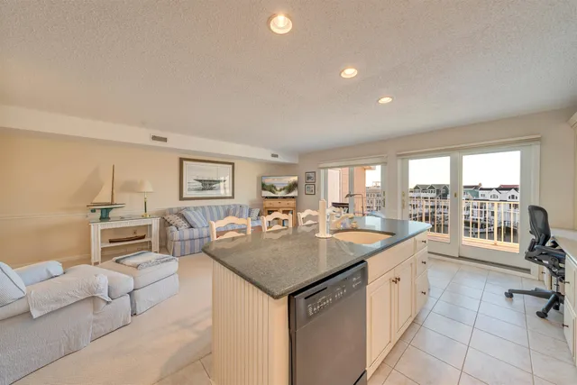 a living room with furniture a flat screen tv and a table