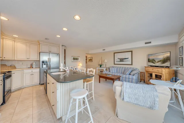 a kitchen with a refrigerator and a dining table
