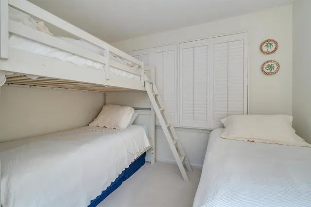 a bedroom with a bed and a large window with the outer view