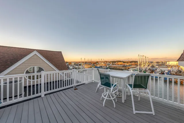 a view of a roof deck dining table and chairs with wooden floor