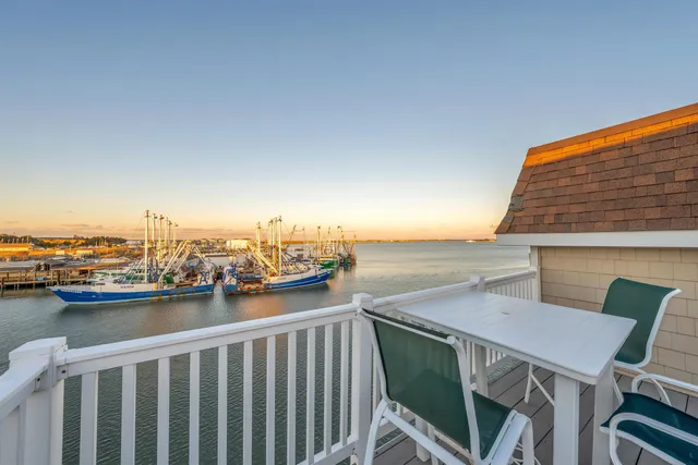 a roof deck with table and chairs