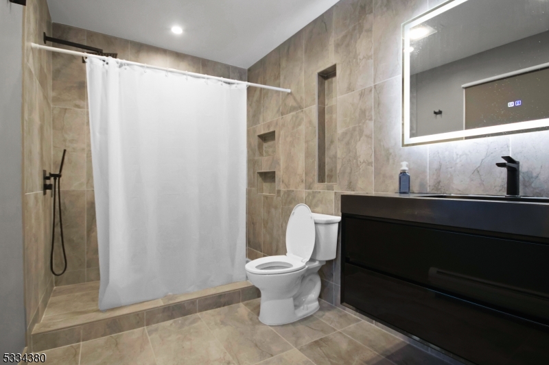 519 East Shore Trail Sparta, NJ 07871 - Photo 14 of 22 a bathroom with a sink a toilet and shower