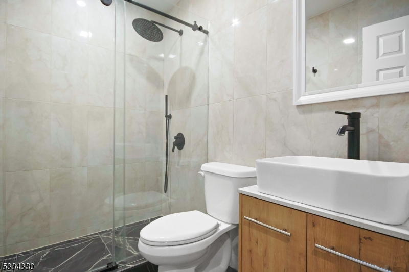 519 East Shore Trail Sparta, NJ 07871 - Photo 15 of 22 a bathroom with a sink a toilet and shower