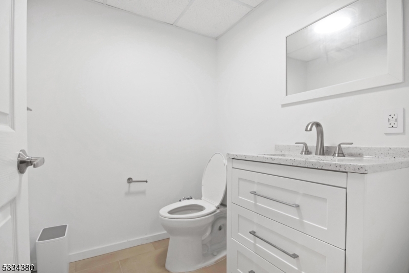519 East Shore Trail Sparta, NJ 07871 - Photo 19 of 22 a bathroom with a toilet sink and mirror