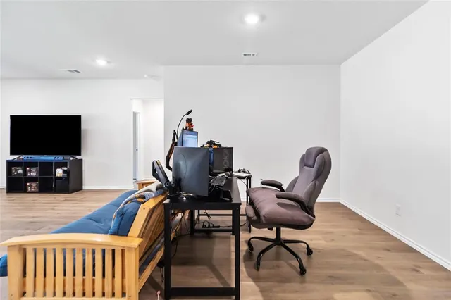 a view of a livingroom with furniture and a flat screen tv