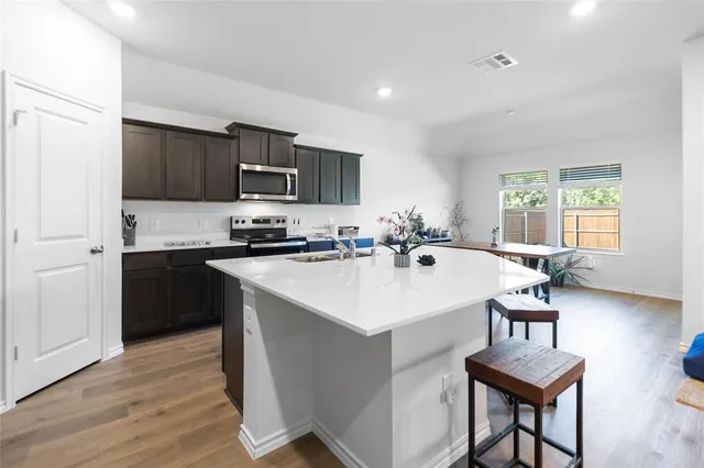 a kitchen with a sink a stove and a refrigerator