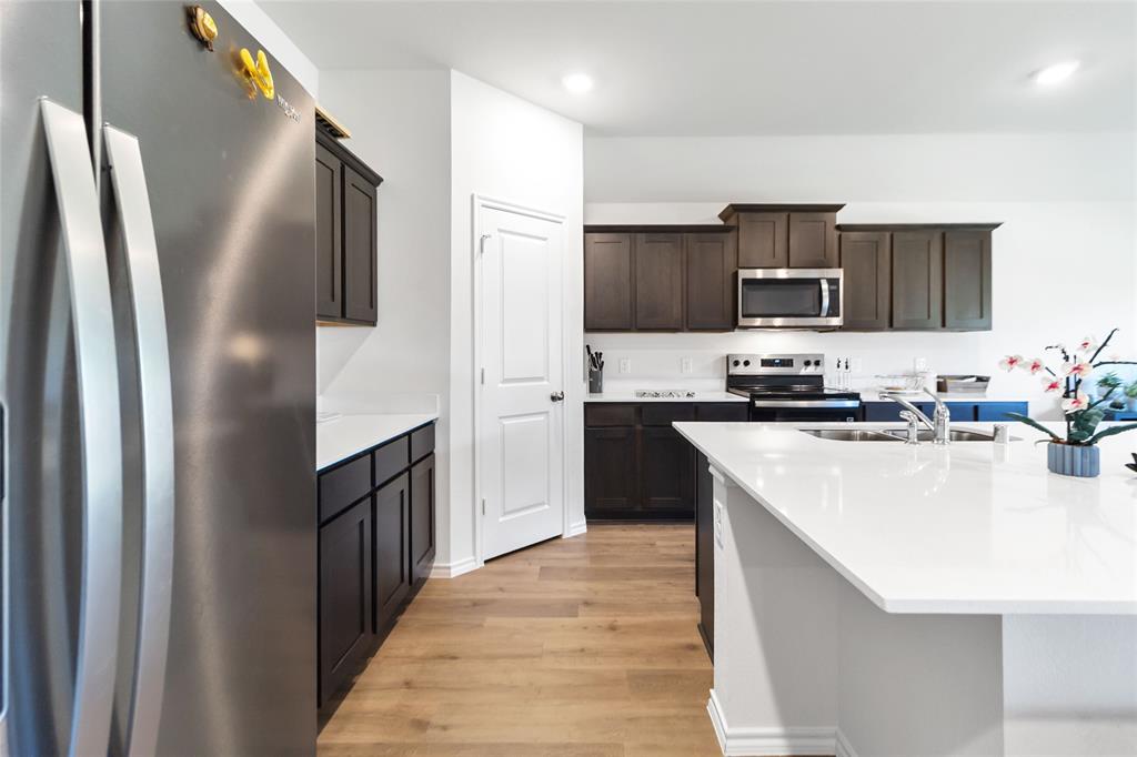 103 Mapleoak Drive Caddo Mills, TX 75135 - Photo 21 of 31 a kitchen with stainless steel appliances granite countertop a refrigerator a sink a stove and oven