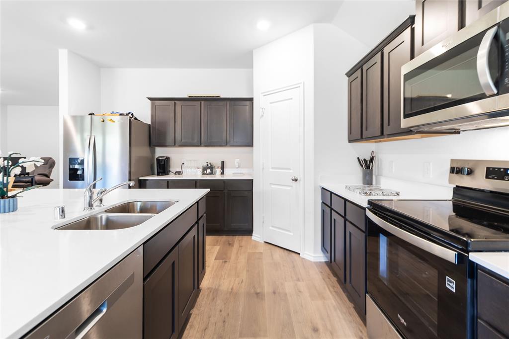 103 Mapleoak Drive Caddo Mills, TX 75135 - Photo 22 of 31 a kitchen with stainless steel appliances granite countertop a sink stove and refrigerator