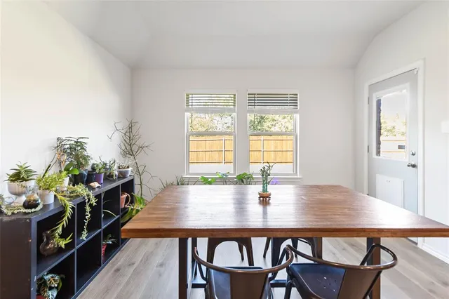 a dining room with furniture and wooden floor