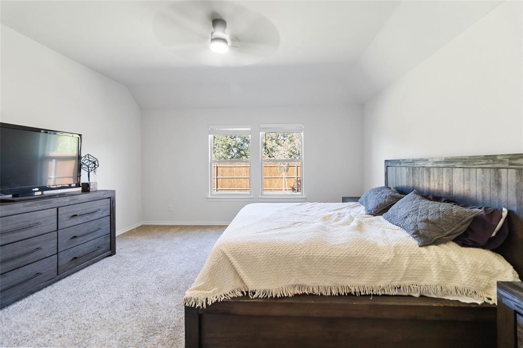 103 Mapleoak Drive Caddo Mills, TX 75135 - Photo 25 of 31 a bedroom with a bed and a flat screen tv