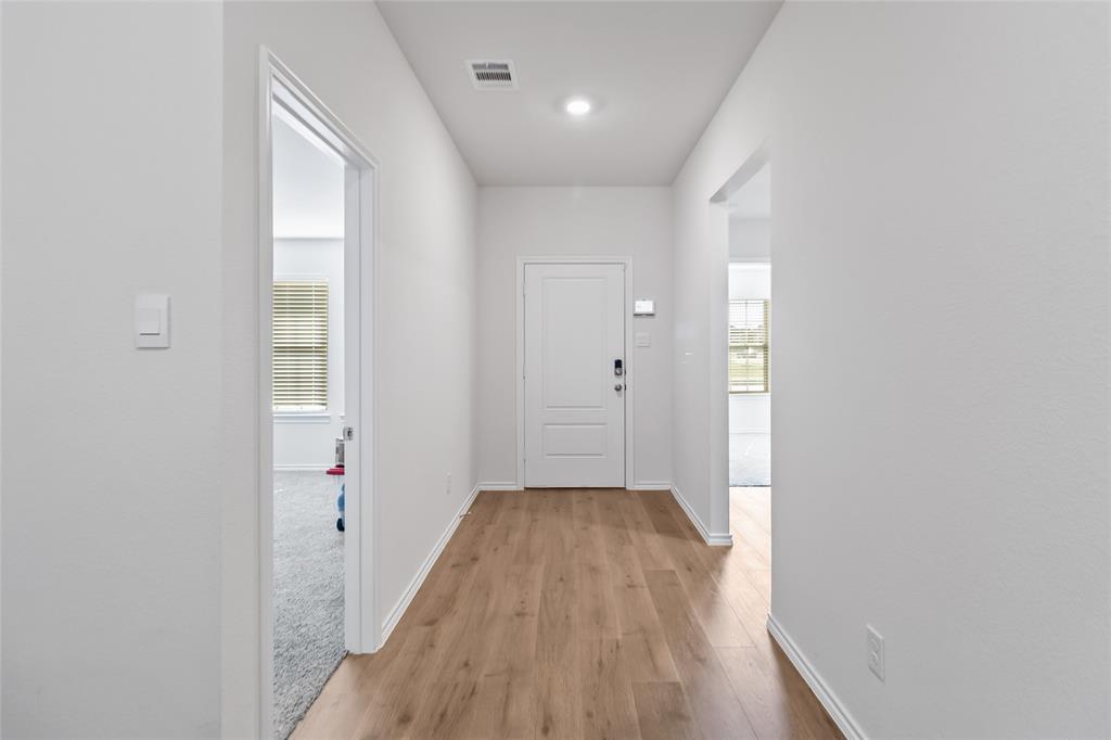 103 Mapleoak Drive Caddo Mills, TX 75135 - Photo 3 of 31 a view of a hallway with wooden floor