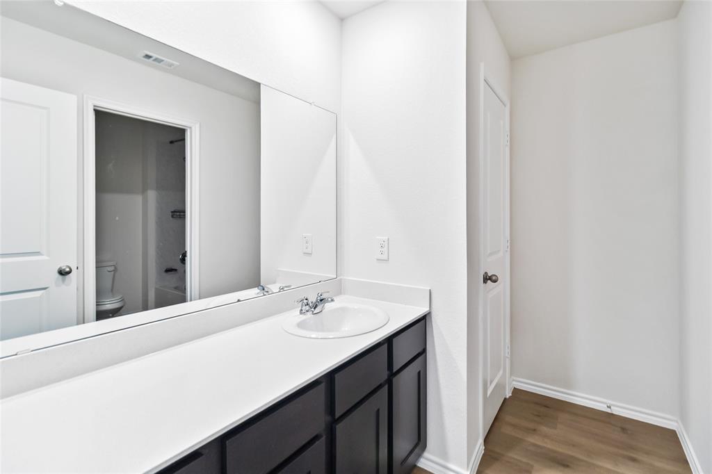 103 Mapleoak Drive Caddo Mills, TX 75135 - Photo 7 of 31 a bathroom with a sink and a mirror