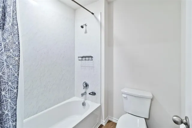 a bathroom with a toilet and a bathtub