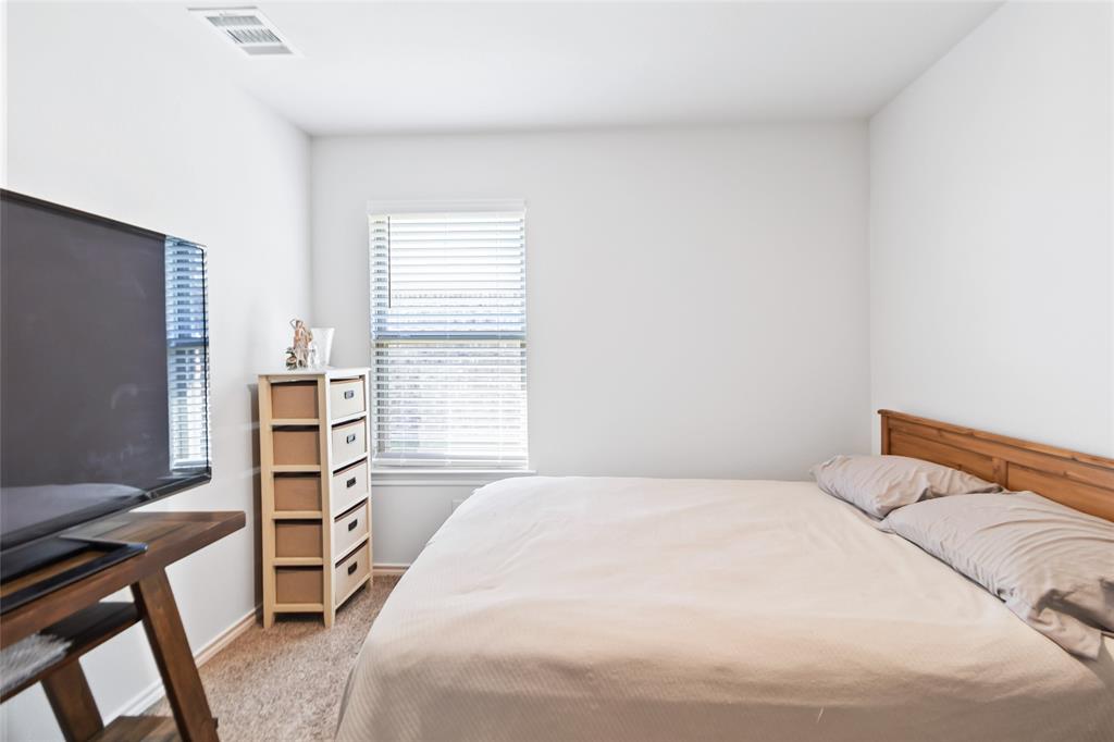 103 Mapleoak Drive Caddo Mills, TX 75135 - Photo 10 of 31 a bedroom with a bed and a window