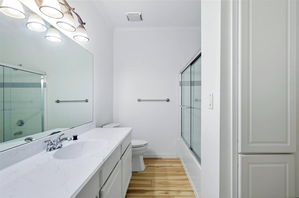 2601 Preston Road, Unit 1201 Plano, TX 75093 - Photo 13 of 31 Primary Full bath featuring combined bath / shower with glass door, vanity, premium material LVP flooring, and crown molding