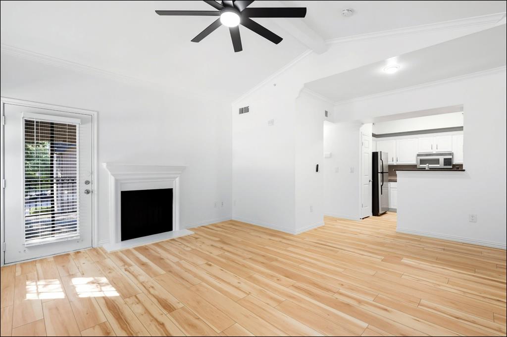2601 Preston Road, Unit 1201 Plano, TX 75093 - Photo 7 of 31 living room with premium material LVP finished floors, a ceiling fan, and vaulted ceiling
