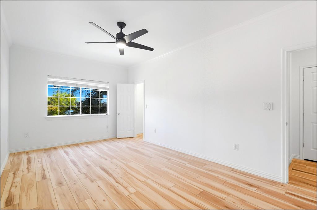 2601 Preston Road, Unit 1201 Plano, TX 75093 - Photo 10 of 31 Primary Bedroom featuring premium material LVP flooring, ceiling fan, ensuite bath, and ornamental molding