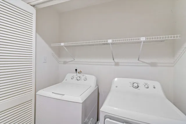 a view of storage and utility room with washer and dryer