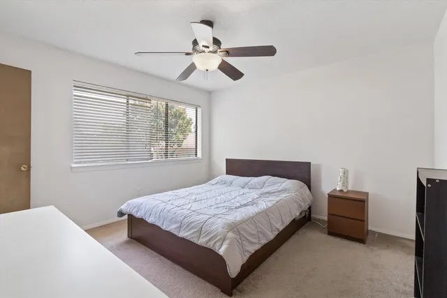 a bedroom with a bed and window
