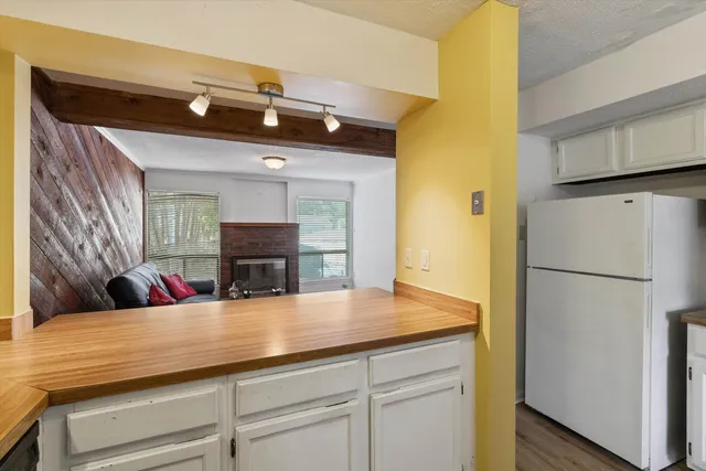 a kitchen with a refrigerator and a sink