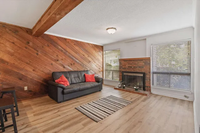 a living room with furniture a fireplace and a table