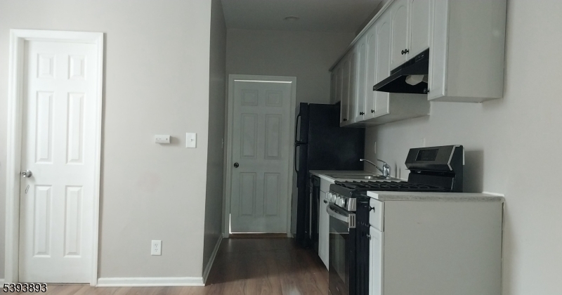 169 Mt Prospect Avenue Newark, NJ 07104 - Photo 14 of 16 a kitchen with stainless steel appliances granite countertop a stove a refrigerator and a microwave