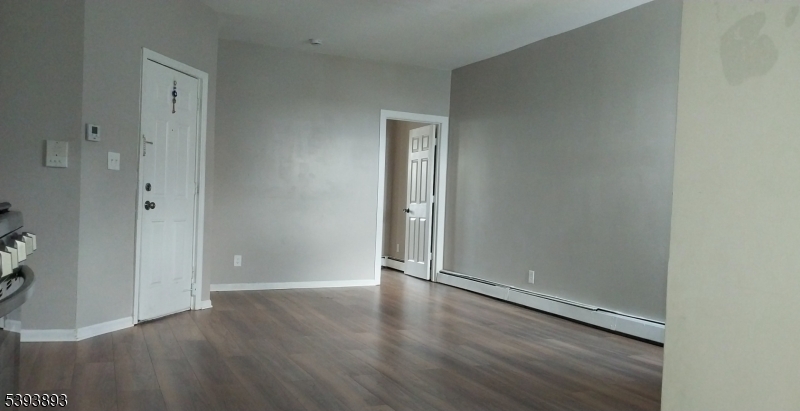 169 Mt Prospect Avenue Newark, NJ 07104 - Photo 15 of 16 an empty room with wooden floor and closet