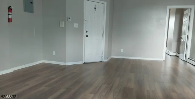 a view of a room with wooden floor and window