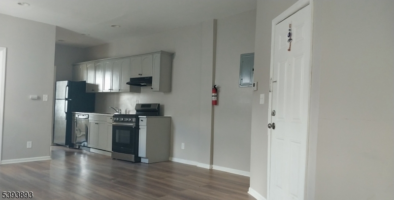 169 Mt Prospect Avenue Newark, NJ 07104 - Photo 6 of 16 a kitchen with a refrigerator and a stove top oven