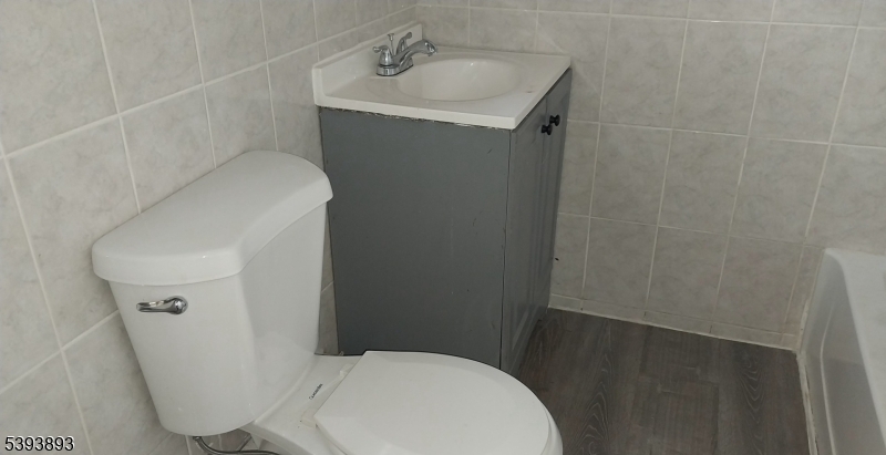 169 Mt Prospect Avenue Newark, NJ 07104 - Photo 7 of 16 a bathroom with a sink and toilet