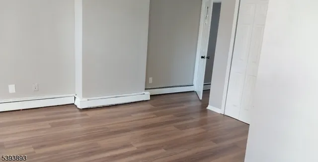 a view of a room with wooden floor