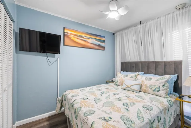 a bedroom with a large bed and a flat screen tv