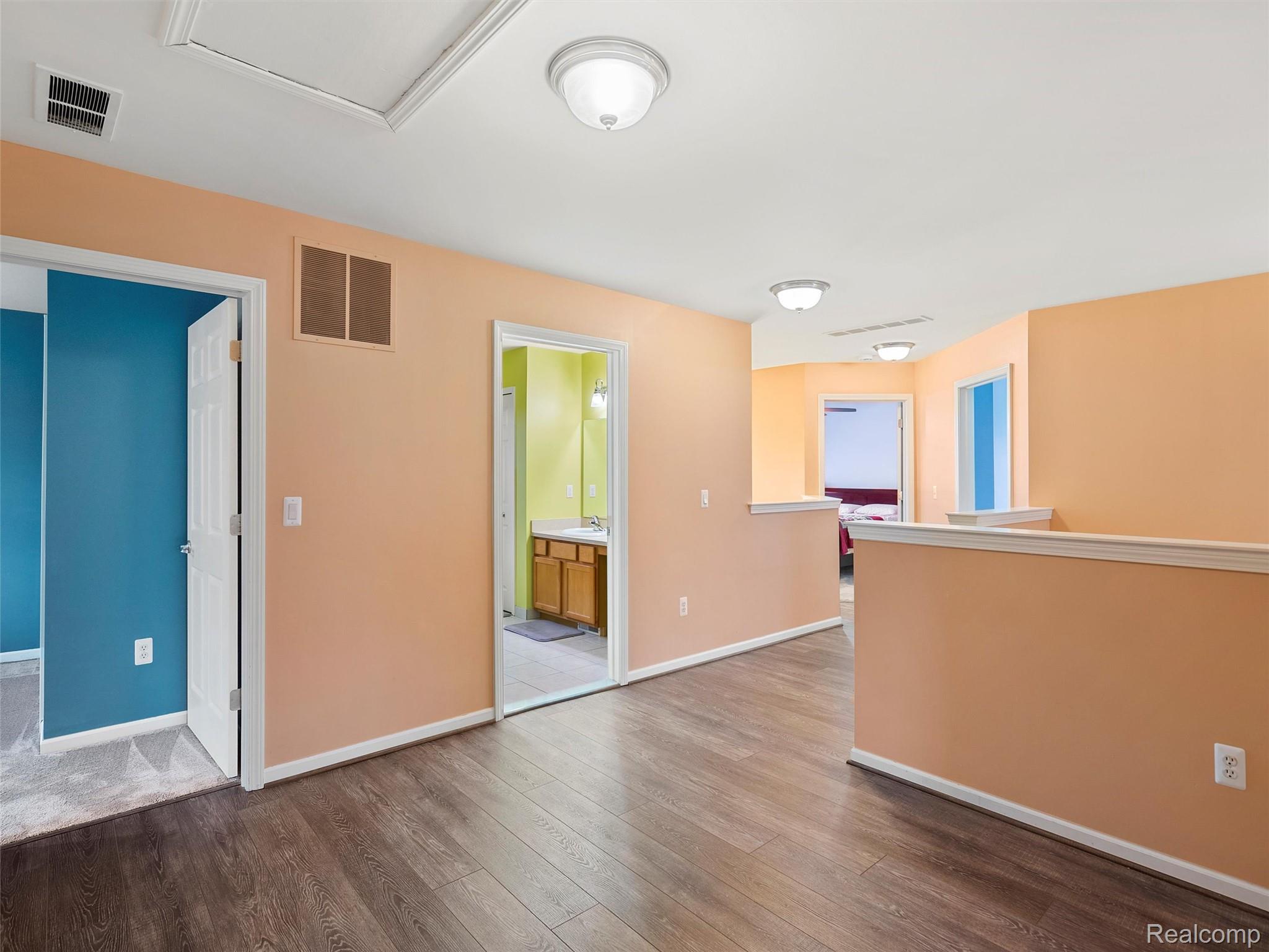 3191 Wren Lane Rochester, MI 48309 - Photo 24 of 63 Empty room with dark wood-style flooring and baseboards