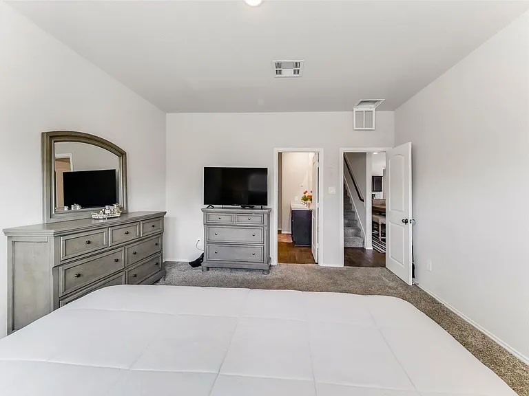 2406 High Spruce Circle Spring, TX 77373 - Photo 19 of 32 a bedroom with a bed and a flat screen tv