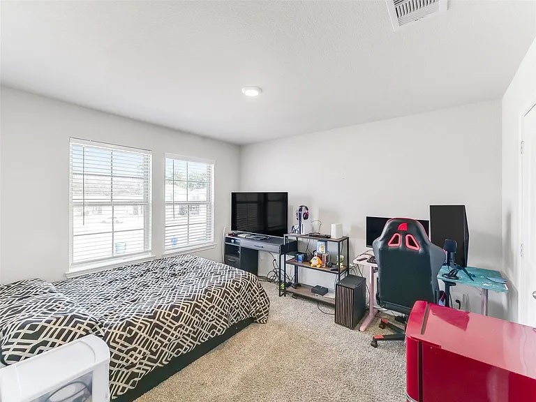 2406 High Spruce Circle Spring, TX 77373 - Photo 26 of 32 a living room with furniture and a flat screen tv