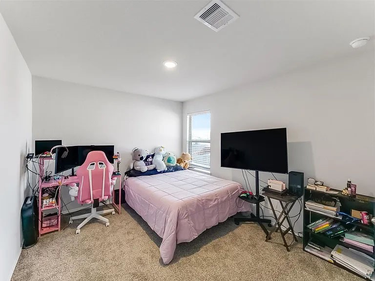2406 High Spruce Circle Spring, TX 77373 - Photo 27 of 32 a bedroom with a bed and a flat screen tv