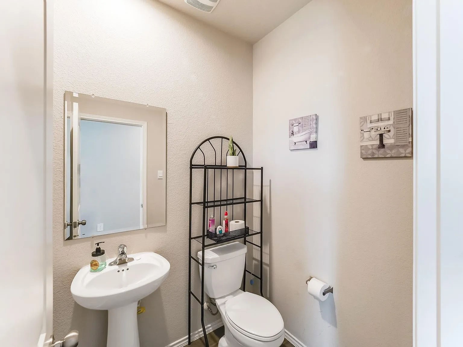 2406 High Spruce Circle Spring, TX 77373 - Photo 4 of 32 a bathroom with a toilet sink and mirror